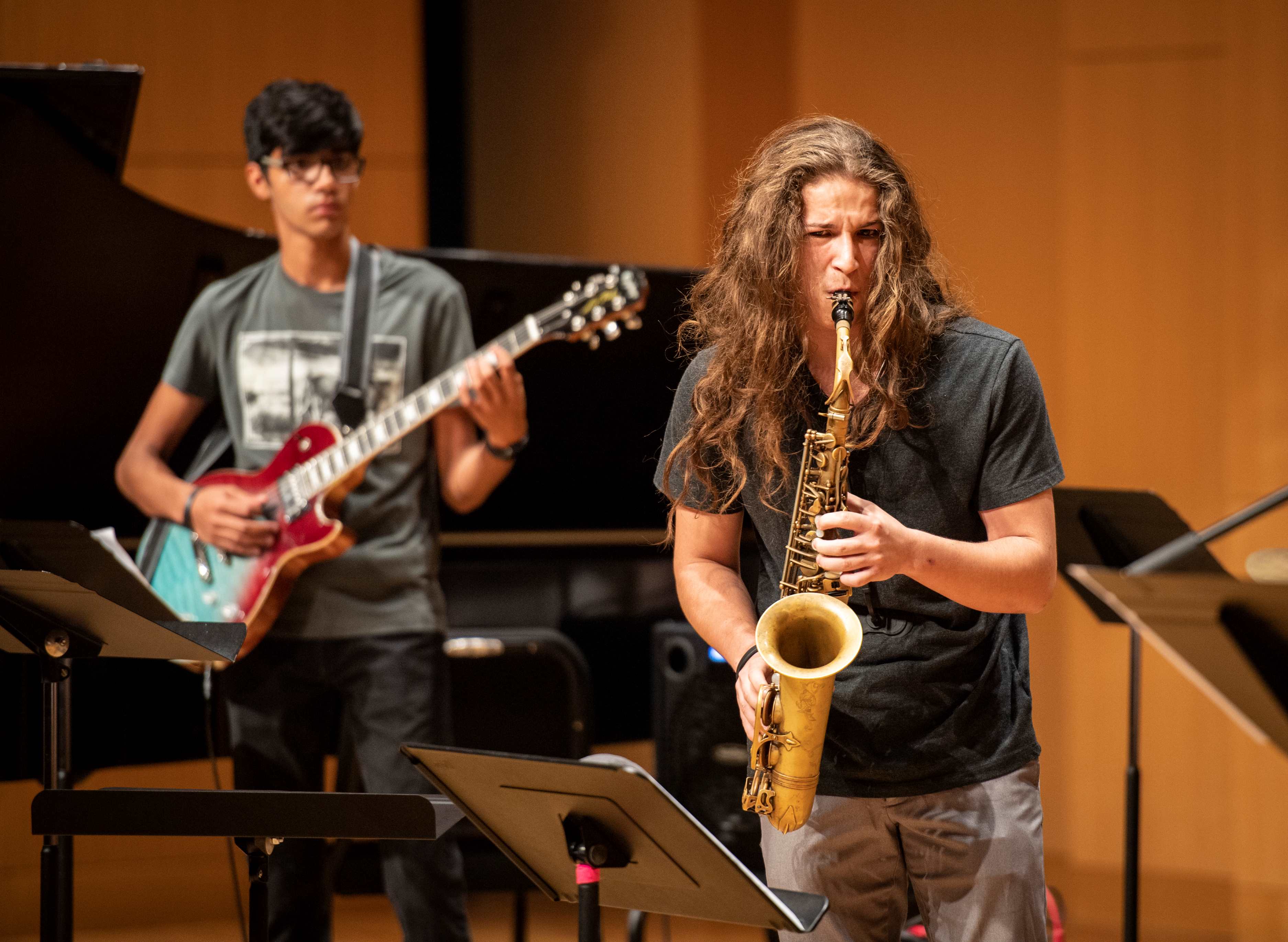 person playing saxophone and guitar